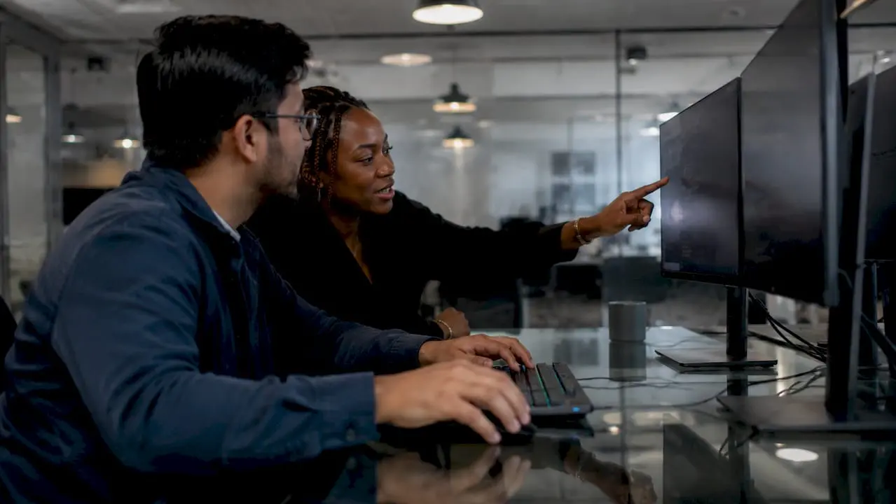 Hands typing and pointing at DevSecOps code layout