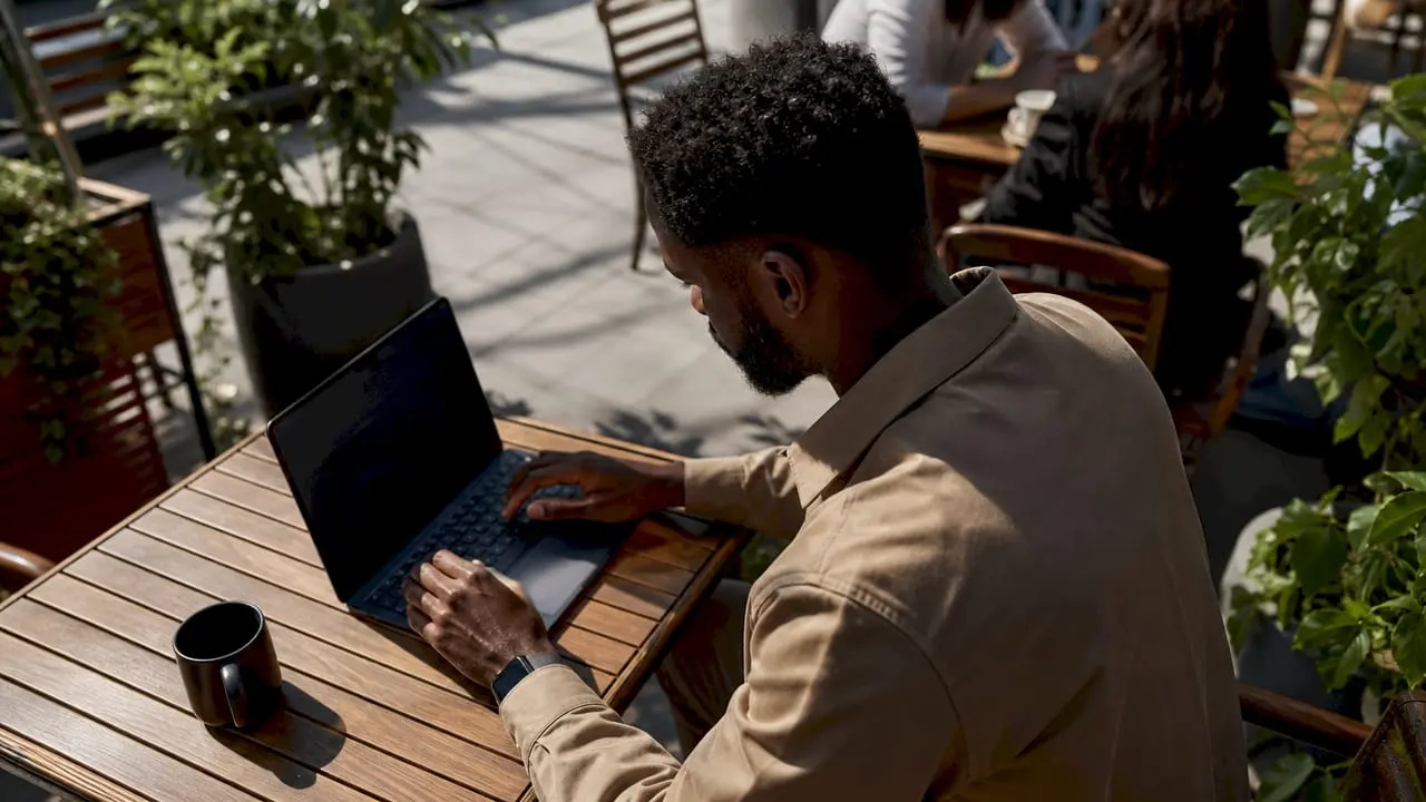 Man using laptop to browse security job board