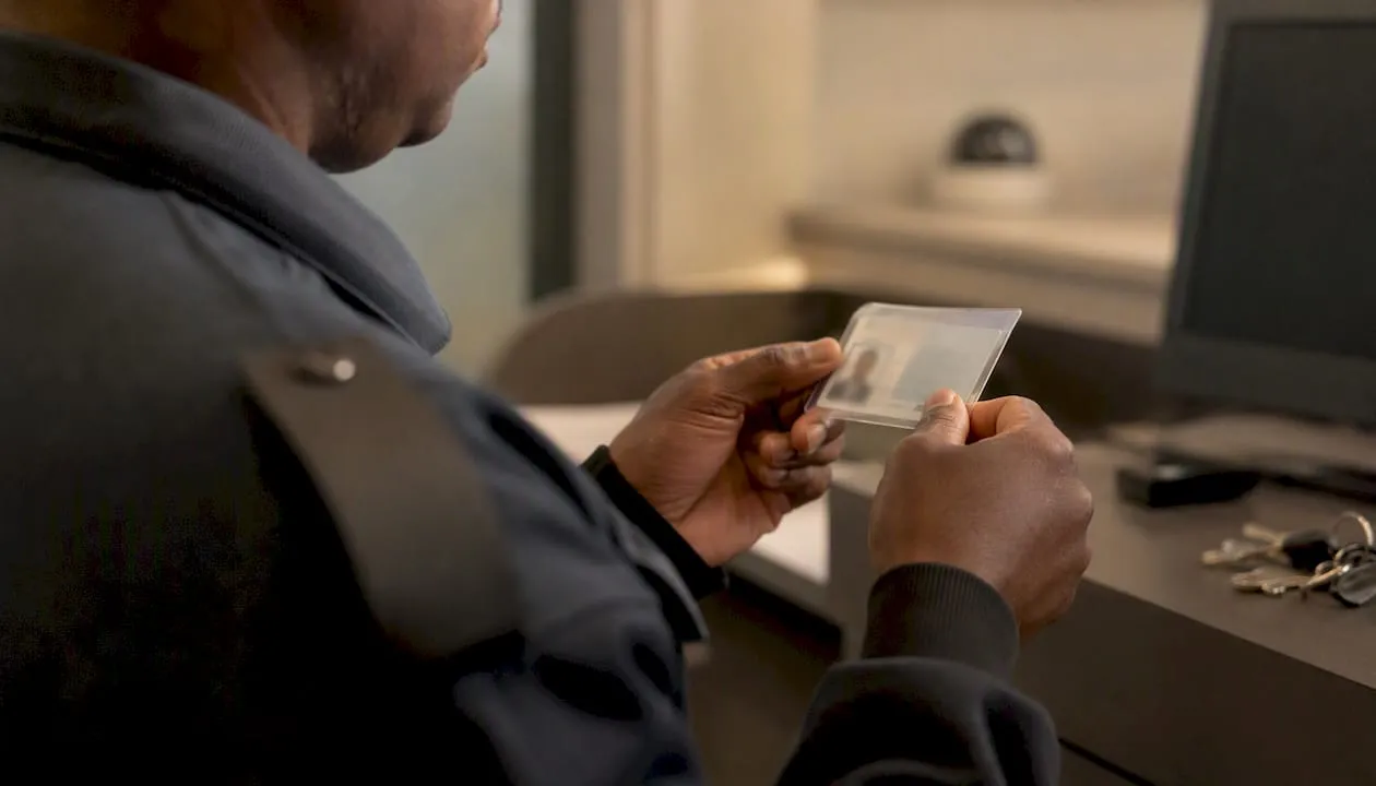 Close-up of security officer checking SIA licence card