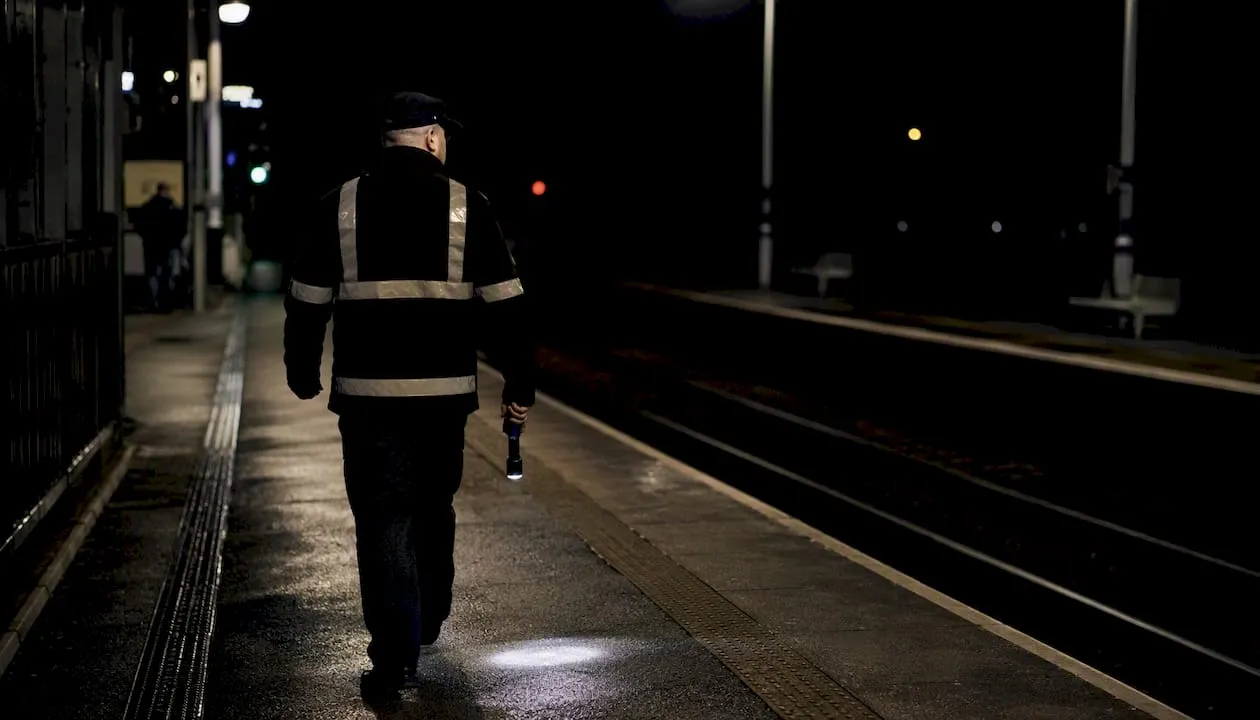 UK station security officer patrolling at night