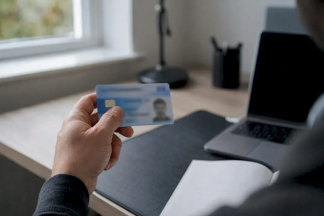 Hand holding a UK SIA licence card for verification